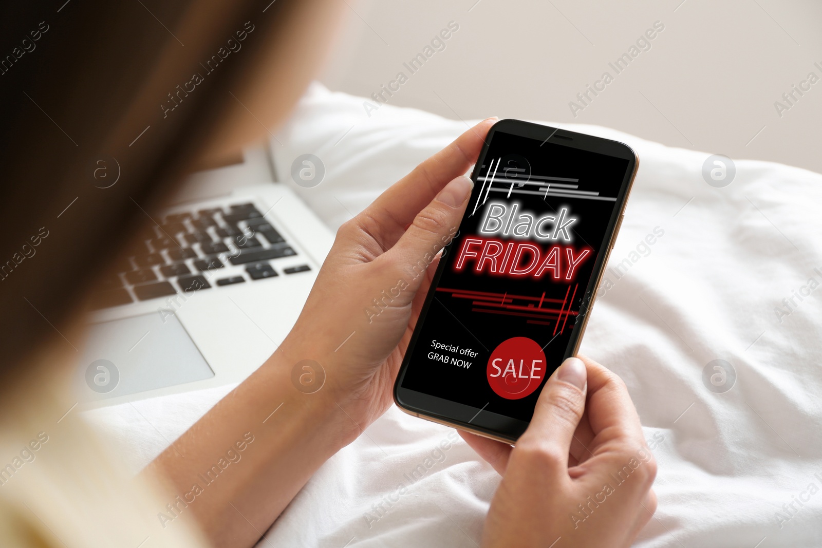 Image of Black Friday. Woman shopping online using smartphone, closeup