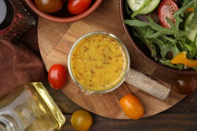 Tasty vinegar based sauce (Vinaigrette), salad and products on wooden table, flat lay