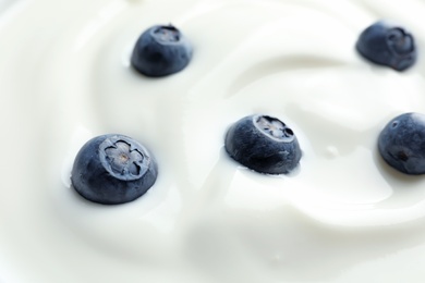 Photo of Tasty fresh yogurt with blueberries, closeup