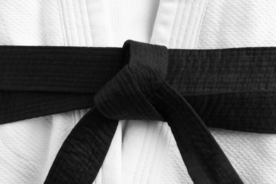 Photo of Martial arts uniform with black belt, closeup
