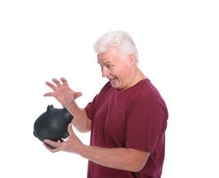 Photo of Emotional mature man with piggy bank on white background