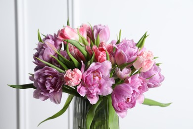 Beautiful bouquet of colorful tulip flowers in vase indoors