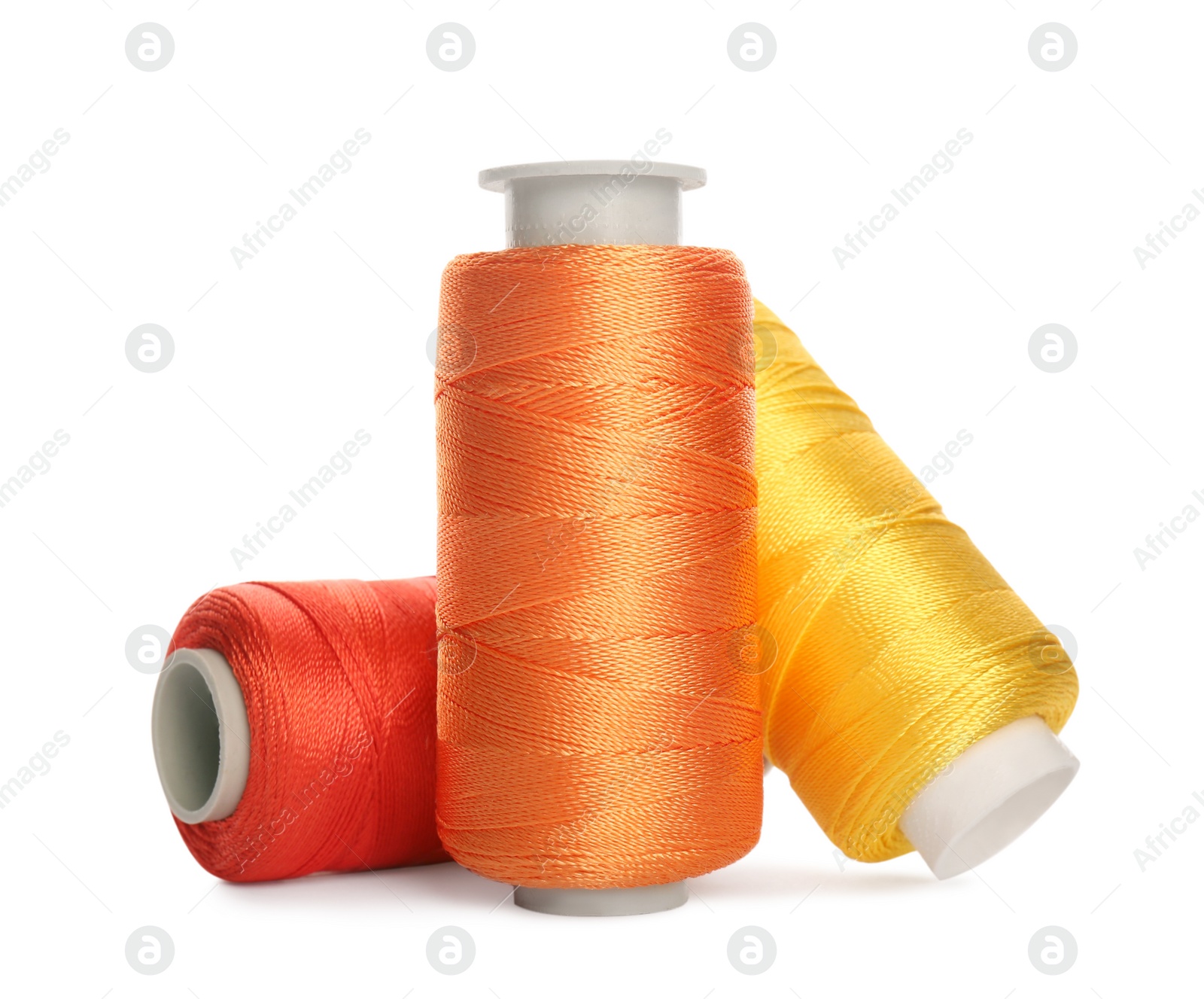 Photo of Different colorful sewing threads on white background