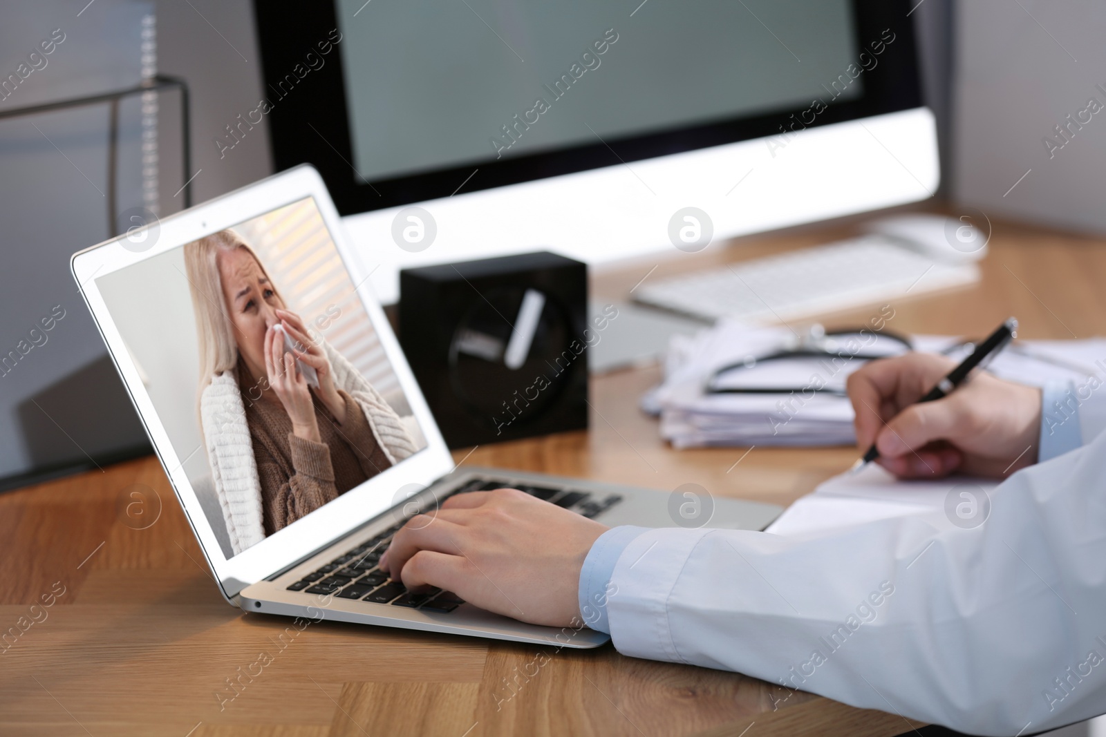 Image of Doctor consulting sick patient online by video chat in medical office, closeup