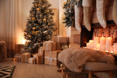Stylish room interior with beautiful Christmas tree and decorative fireplace