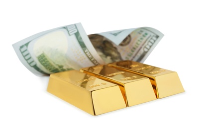 Shiny gold bars and dollar bill on white background