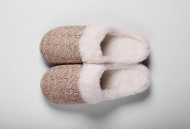 Pair of beautiful soft slippers on white background, top view