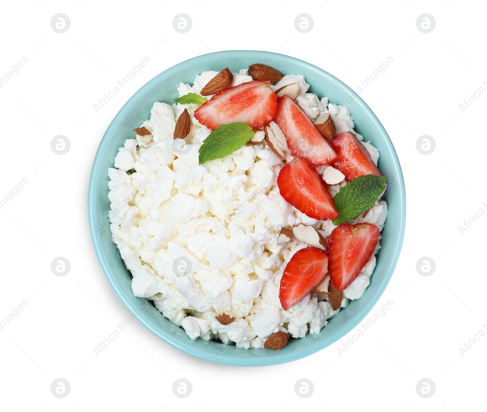 Photo of Fresh cottage cheese with strawberry and almond in bowl isolated on white, top view