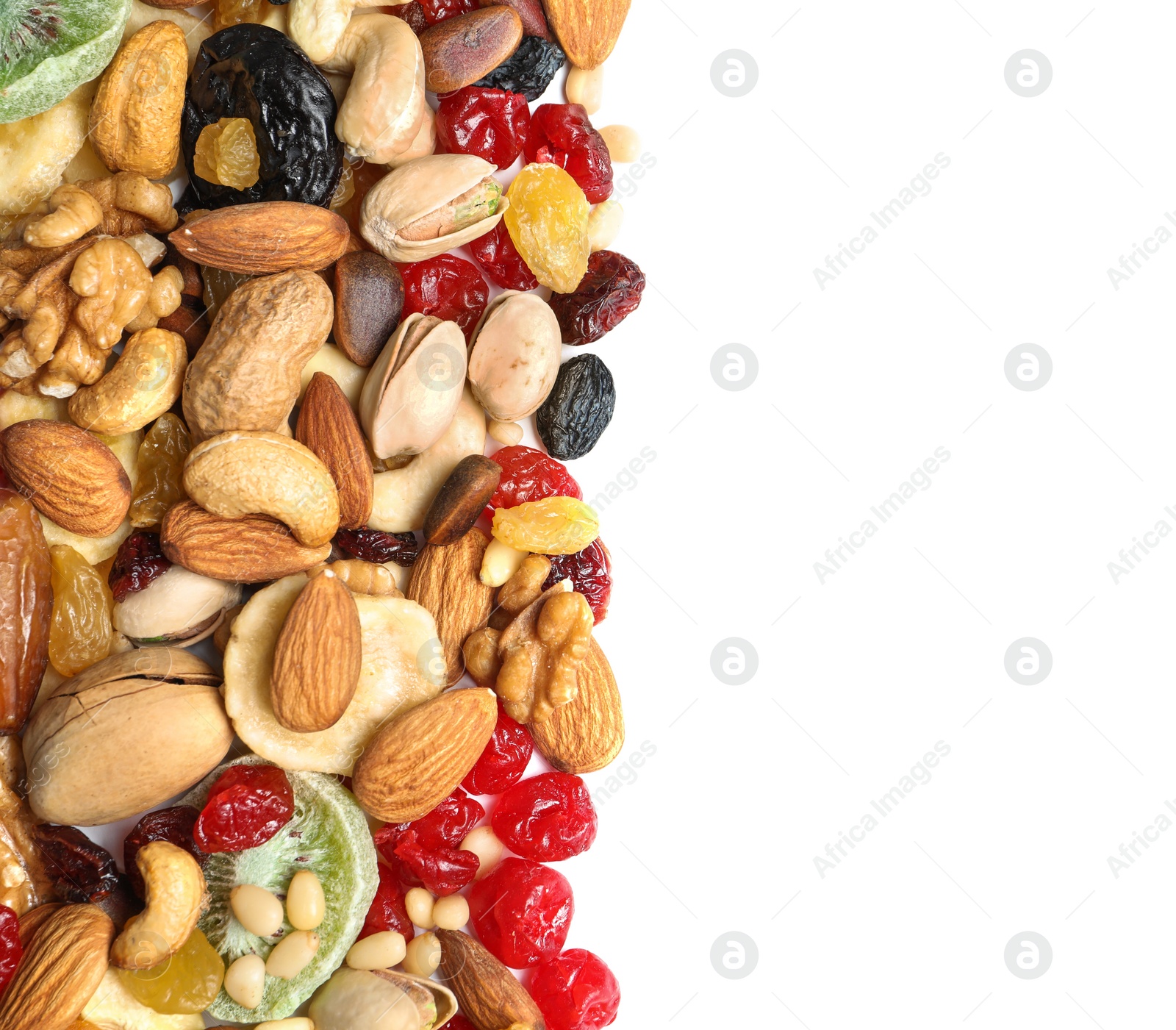 Photo of Different dried fruits and nuts on white background, top view. Space for text