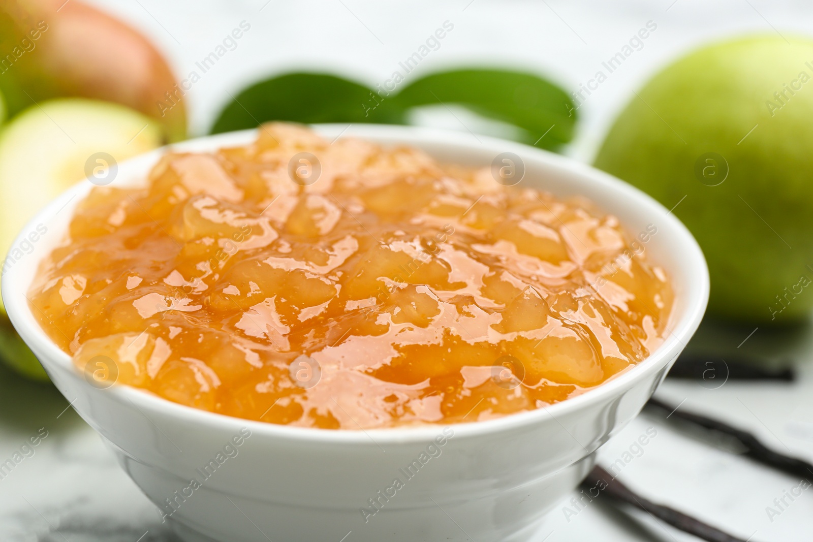 Photo of Delicious pear jam in bowl on table, closeup