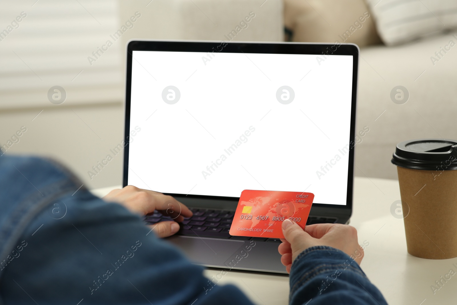 Photo of Woman with credit card using laptop at white table, closeup