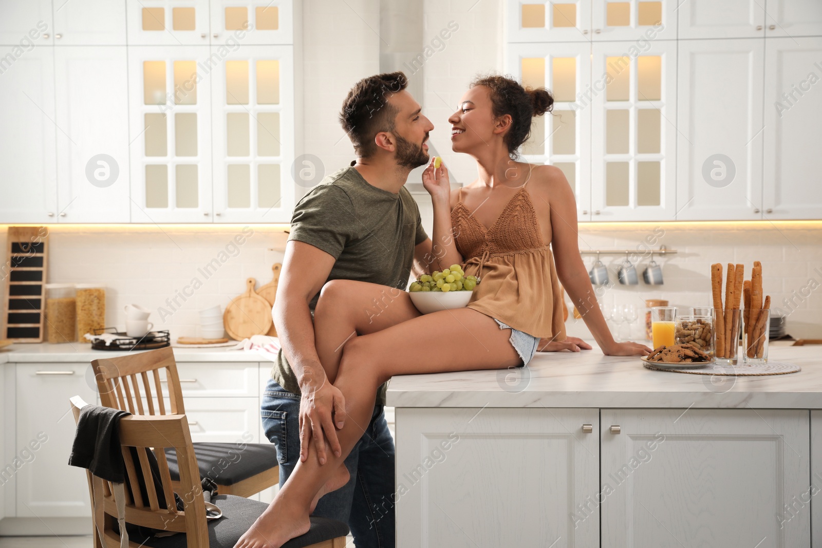 Photo of Lovely couple enjoying time together in kitchen at home