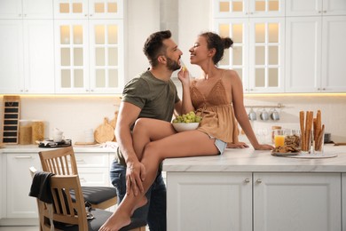 Photo of Lovely couple enjoying time together in kitchen at home