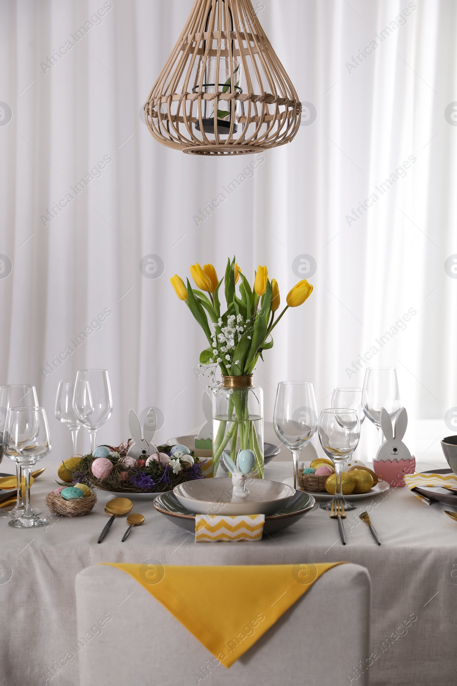 Photo of Beautiful Easter table setting with festive decor indoors