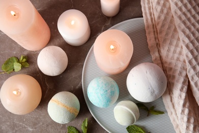 Flat lay composition with bath bombs, candles and mint leaves on table