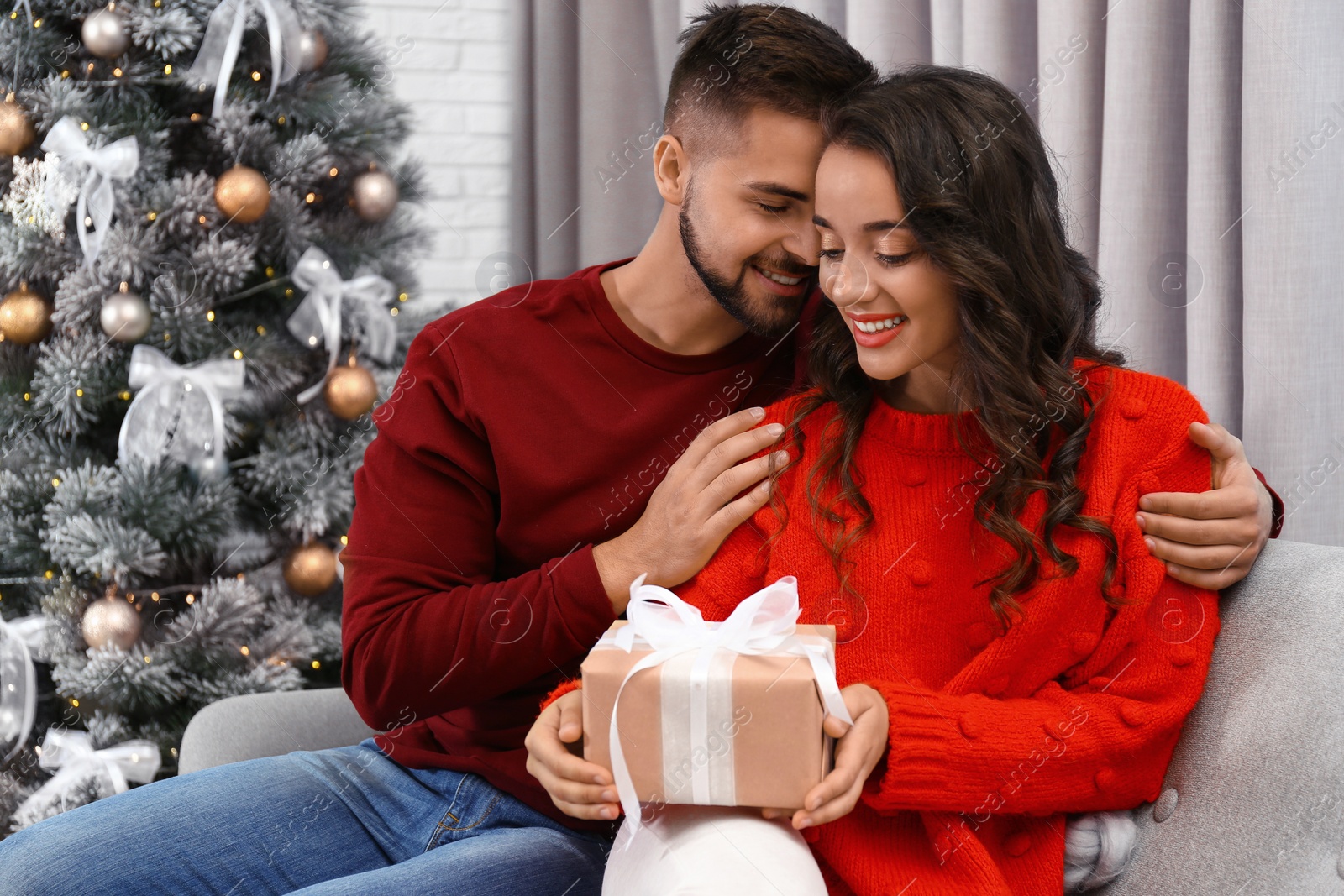 Image of Lovely couple celebrating Christmas together at home