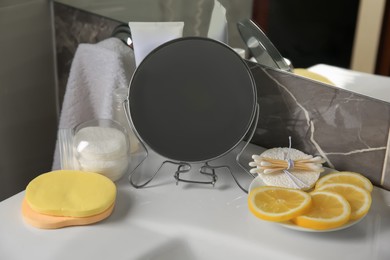 Lemon face wash. Fresh citrus fruits, personal care products and mirror on sink in bathroom