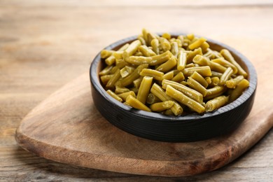 Delicious canned green beans on wooden table