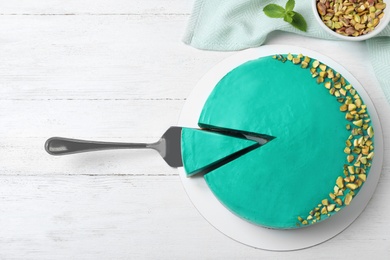 Delicious homemade spirulina cheesecake served on white wooden table, top view