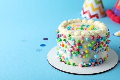 Photo of Cute bento cake with tasty cream on light blue background, space for text