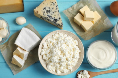 Photo of Different dairy products on blue wooden table, flat lay