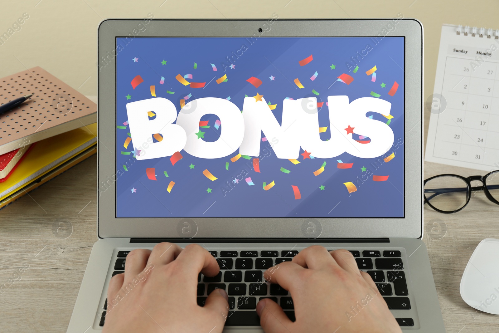 Image of Bonus gaining. Woman using laptop at wooden table, closeup. Illustration of falling confetti and word on device screen