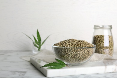 Photo of Bowl of hemp seeds on marble table