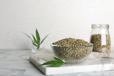 Bowl of hemp seeds on marble table