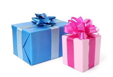 Photo of Pink and light blue gift boxes with bows on white background