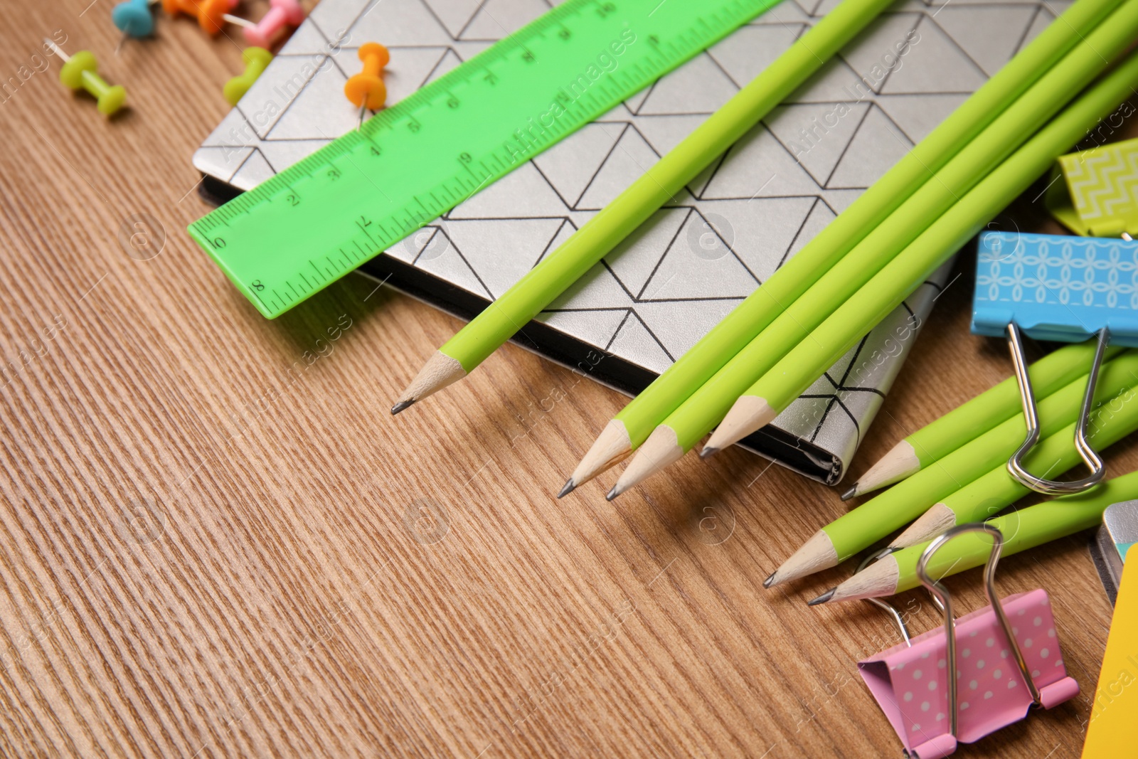 Photo of Different stationery on wooden table. Back to school