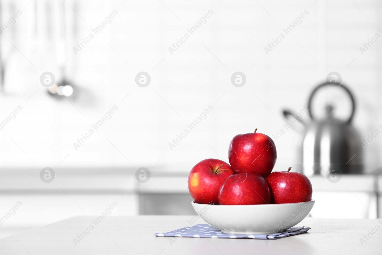 Photo of Bowl of fresh red apples on kitchen counter. Space for text