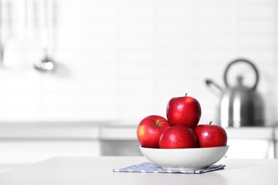 Photo of Bowl of fresh red apples on kitchen counter. Space for text