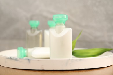 Photo of Mini bottles of cosmetic products on table, closeup