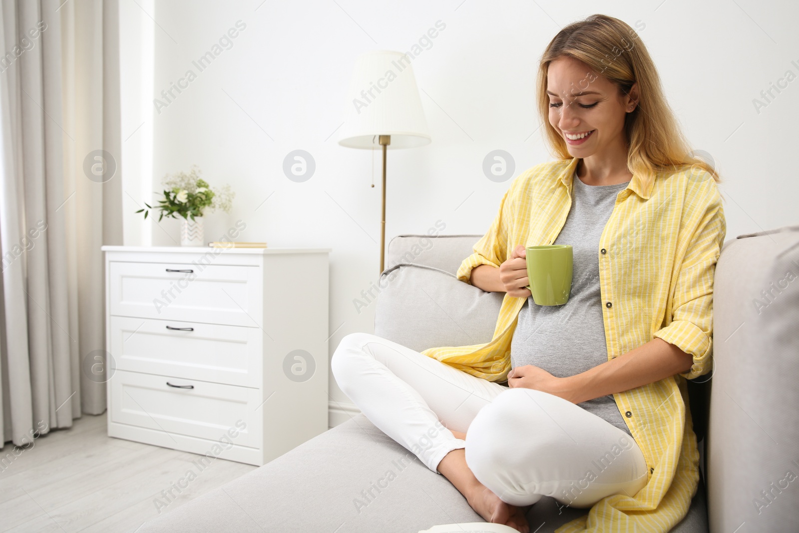 Photo of Beautiful pregnant woman drinking tea at home