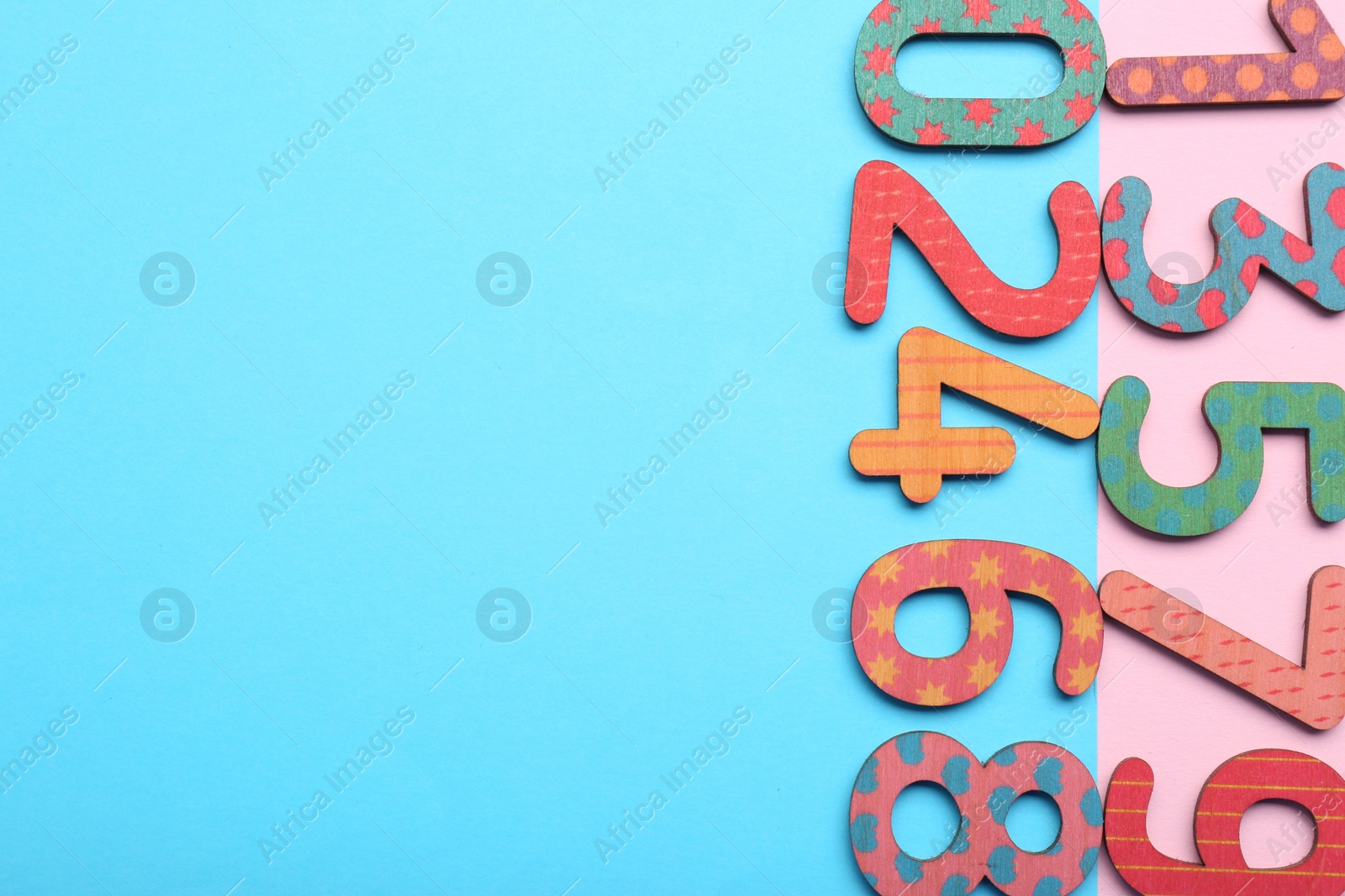 Photo of Wooden numbers on colorful background, flat lay. Space for text