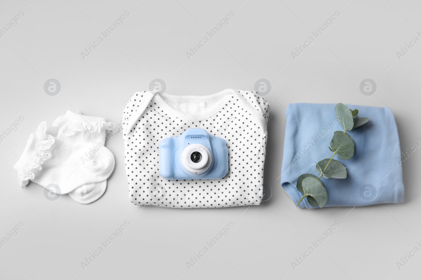 Photo of Flat lay composition with toy camera on light grey background. Future photographer