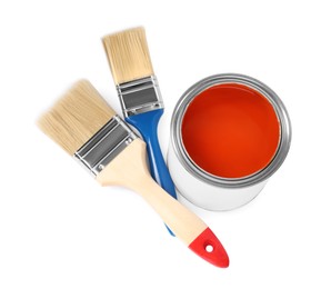 Photo of Can of orange paint and brushes on white background, above view