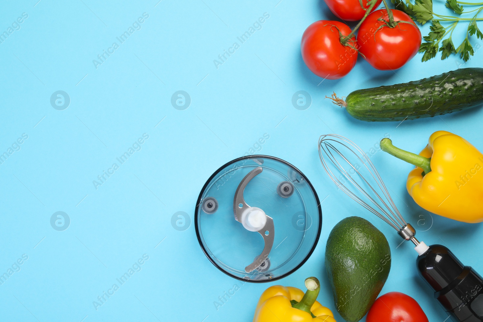 Photo of Hand blender kit and fresh products on light blue background, flat lay. Space for text