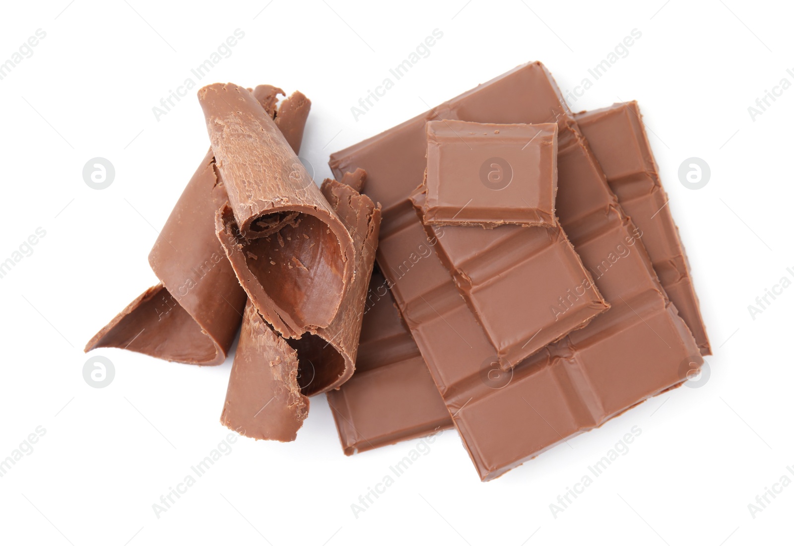 Photo of Pieces of tasty chocolate bar and shavings isolated on white, top view