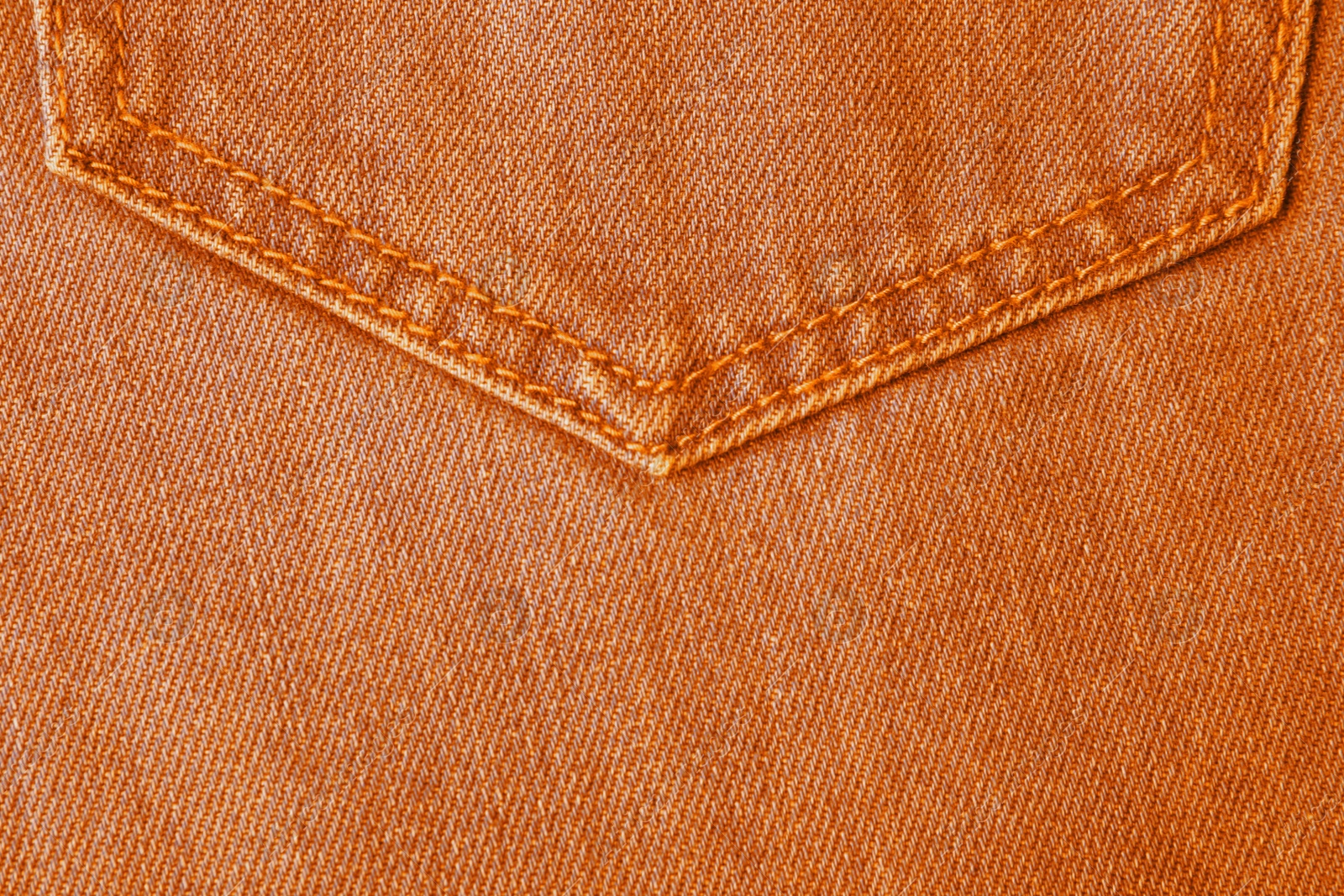 Image of Texture of orange jeans as background, closeup