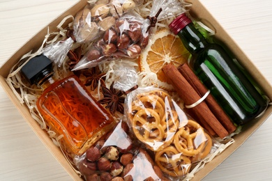 Photo of Stylish gift set in box on white wooden table, top view