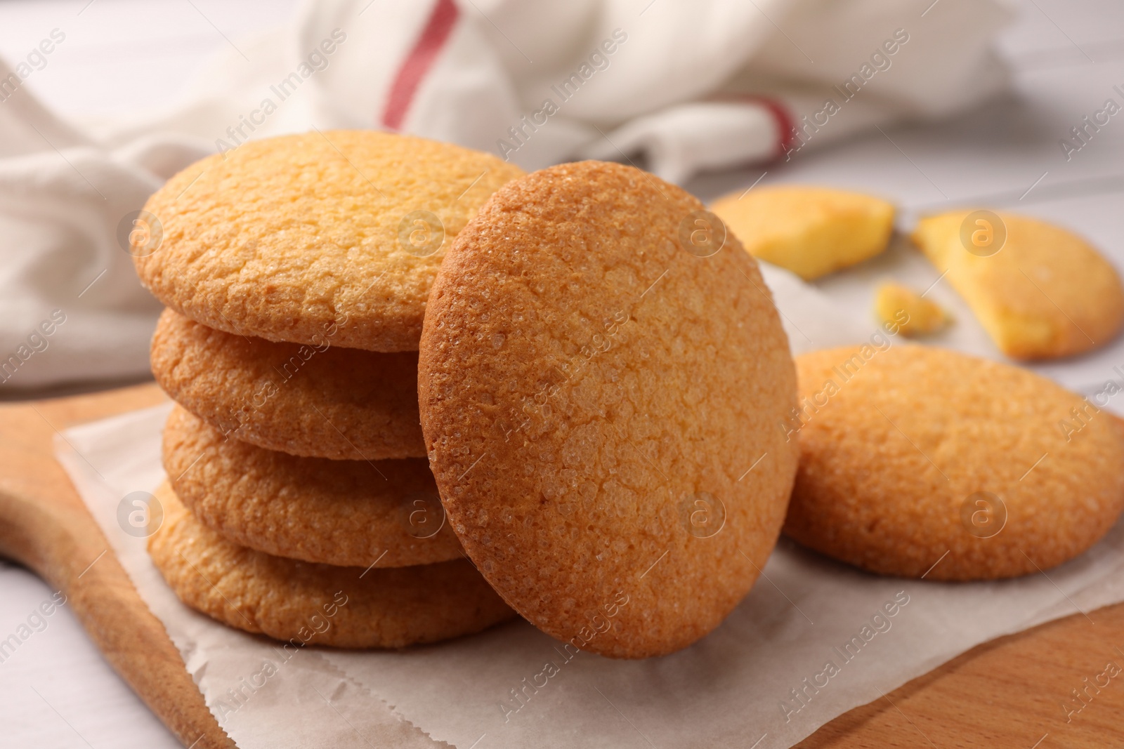 Photo of Delicious Danish butter cookies on wooden board, closeup