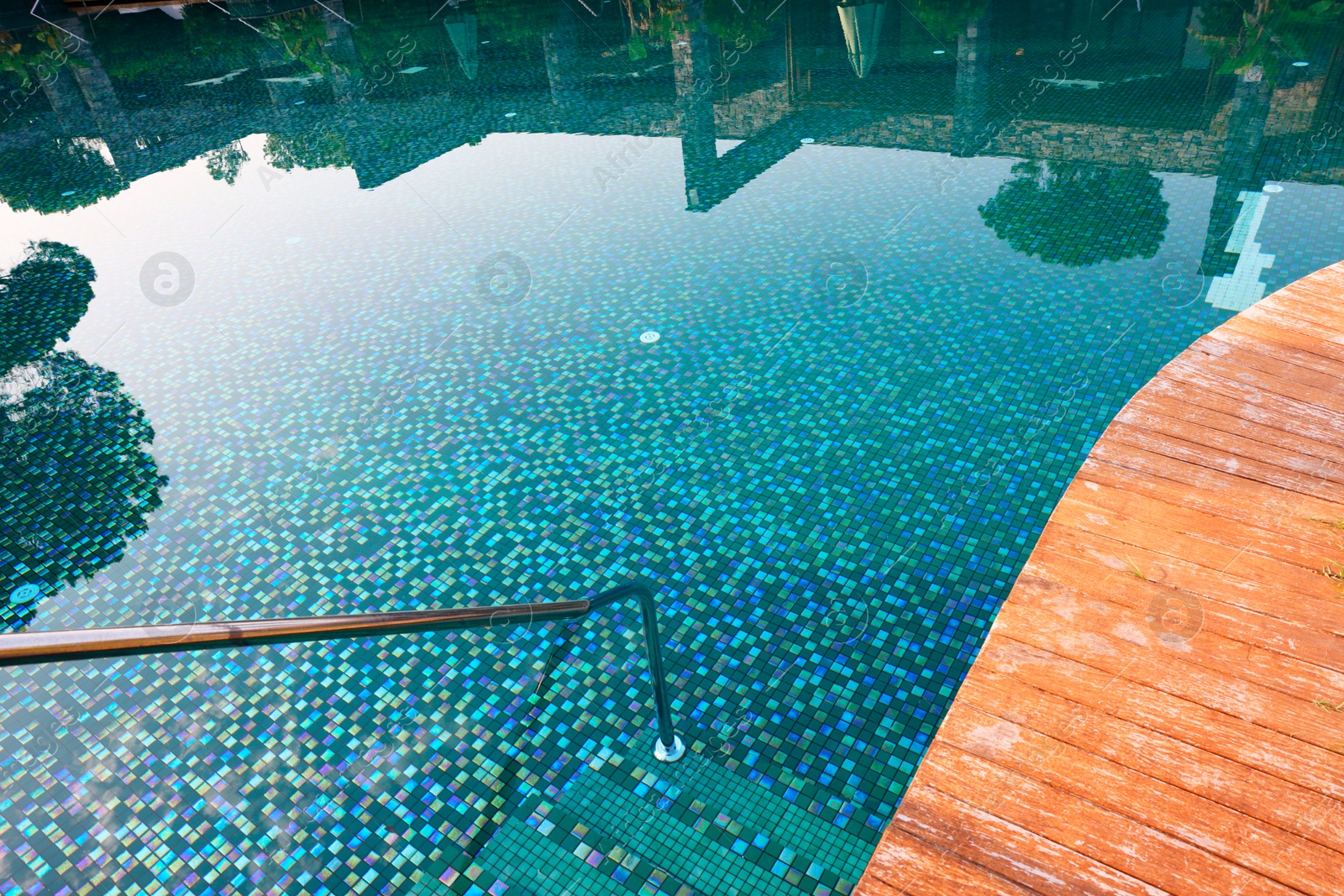 Photo of Outdoor swimming pool with steps and rail at resort