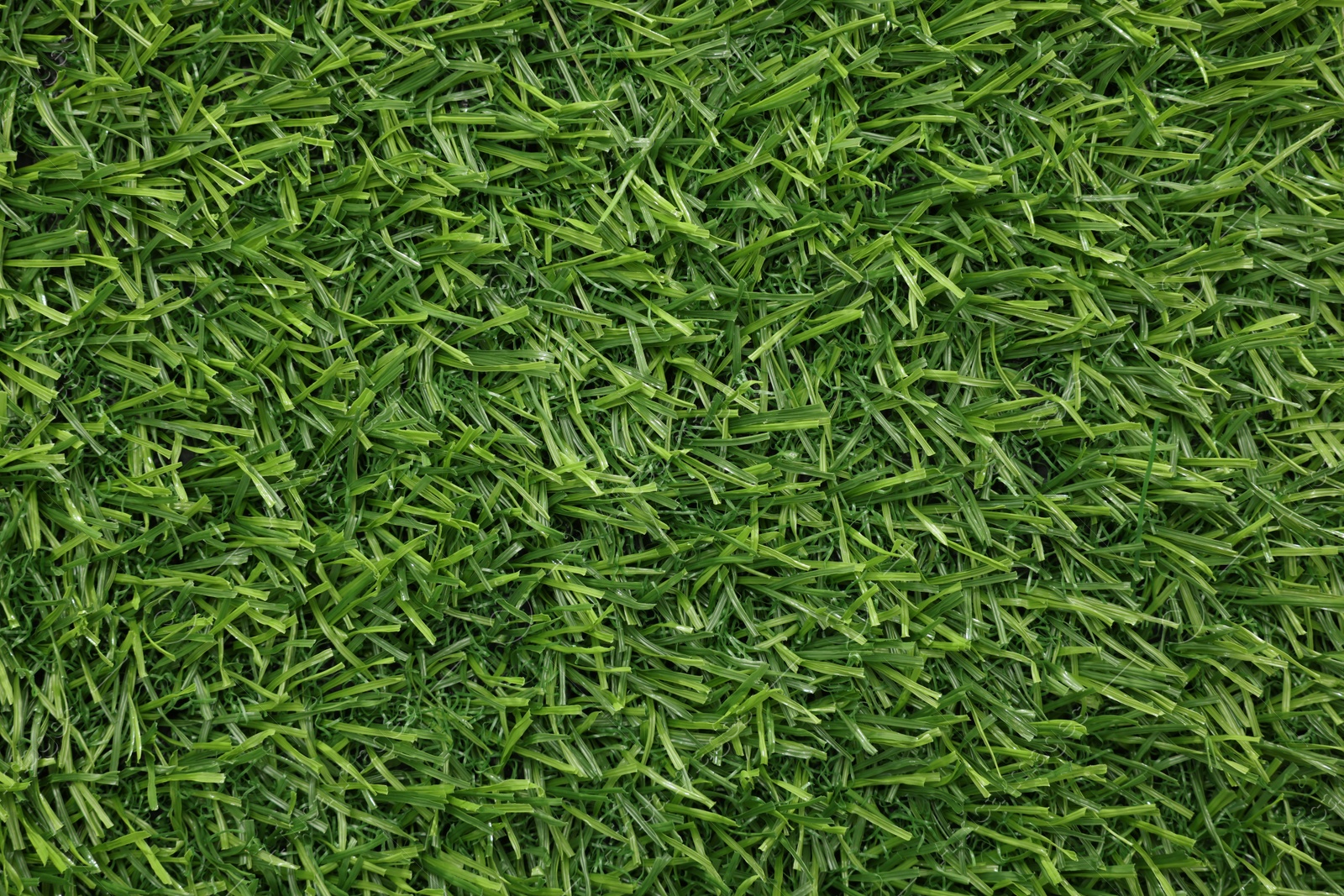 Photo of Green artificial grass as background, top view