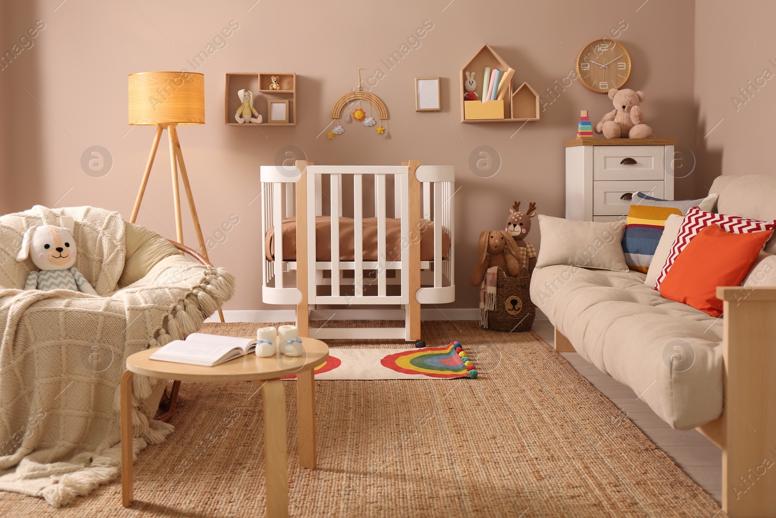 Photo of Baby room interior with stylish furniture and comfortable crib