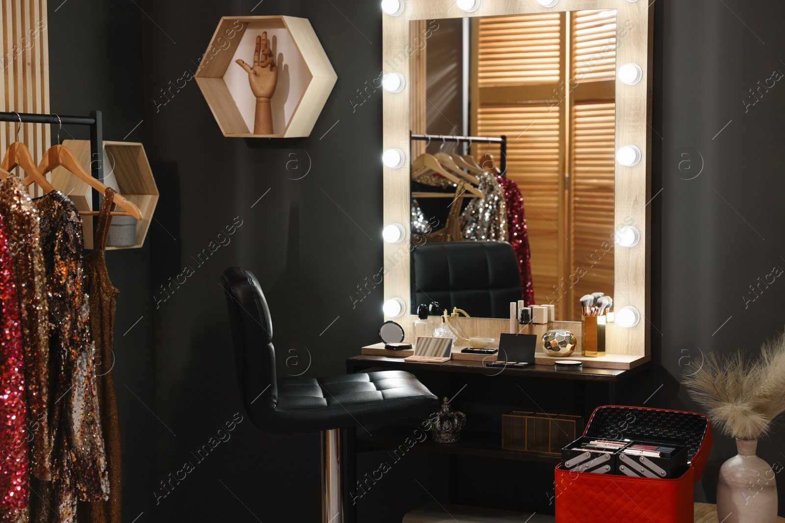 Photo of Makeup room. Stylish mirror near dressing table with beauty products and chair indoors