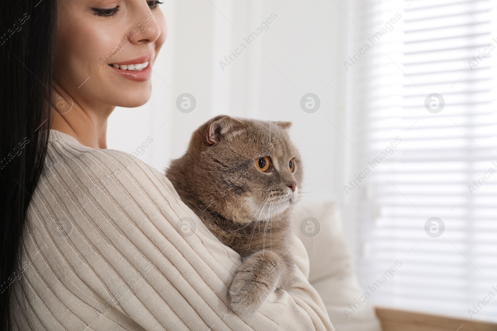 Photo of Woman with her adorable cat at home