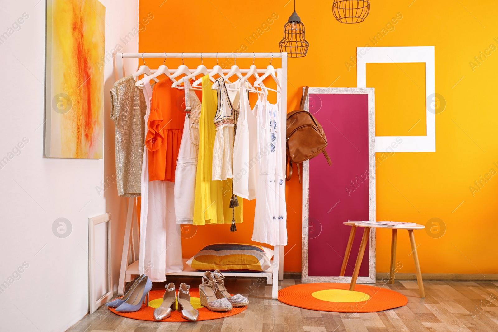 Photo of Stylish dressing room interior with clothes rack and mirror