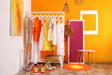 Stylish dressing room interior with clothes rack and mirror