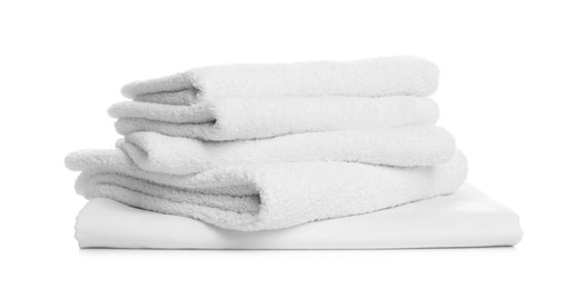 Photo of Stack of towels and bed sheet on white background